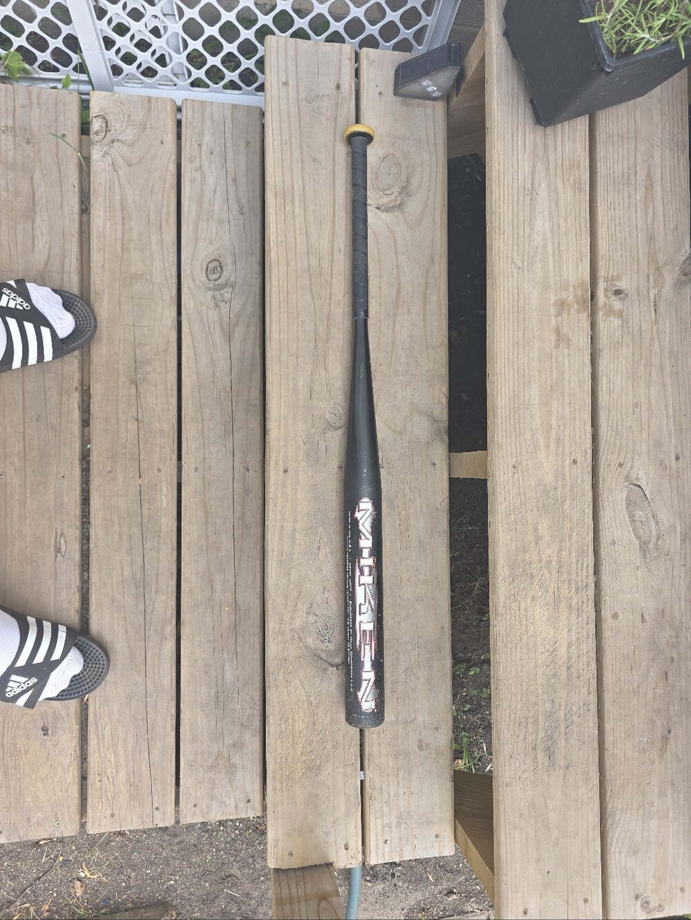 Black Baseball Bat with Yellow Knob.